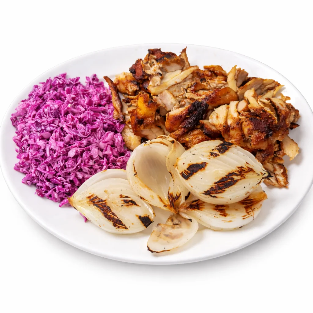 Chicken shawarma platter with a side of vibrant purple cabbage salad and grilled white onions