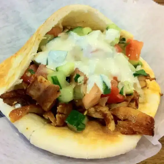 Warm stuffed pita sandwich packed with grilled chicken shawarma meat and diced fresh vegetables